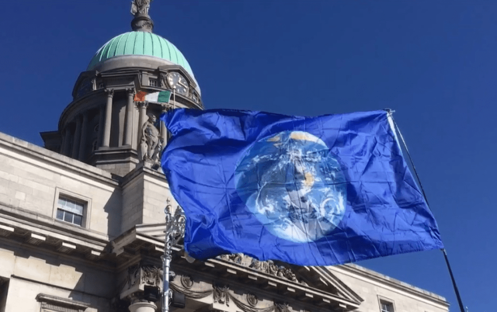 Earth Flag in front of Irish Dept of Environment, XR march, Sept, 2019